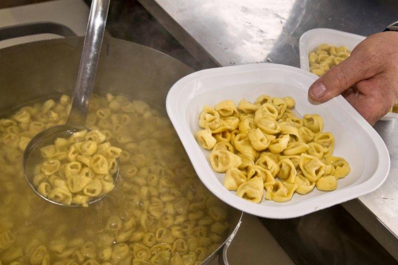 pasta 904576990 someone scooping tortellini into a bowl
