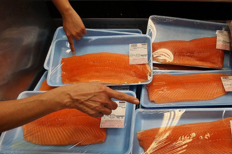 salmon 82470935 people picking out salmon at a grocery store