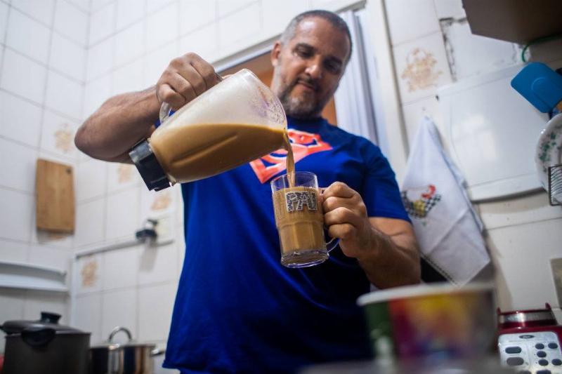 smoothie 1213010442 man pouring himself a smoothie