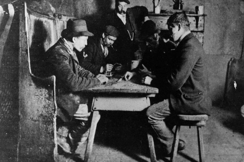 Men play card games in a tavern in 1860.