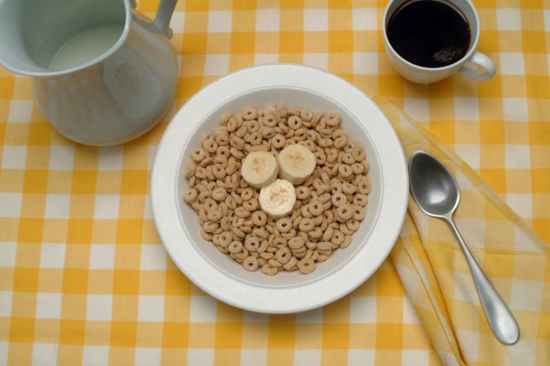 Cereal & Coffee A bowl of cereal with banana slices is seen.
