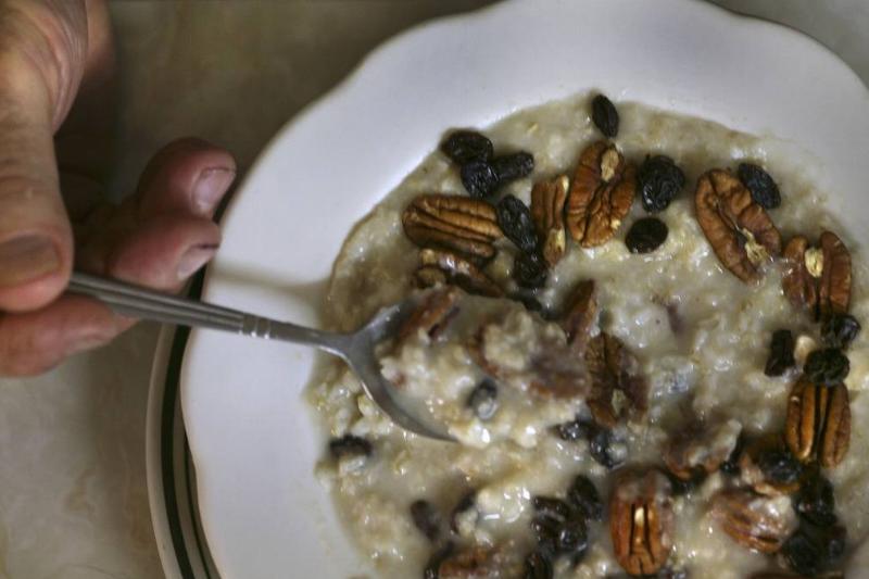 eating oatmeal A person digs a spoon into oatmeal.