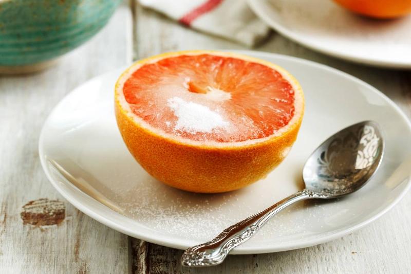 grapefruit-957732868 Half of a grapefruit with sugar on top is served for breakfast.