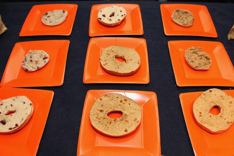 half bagel Orange square plates each hold half of a bagel.
