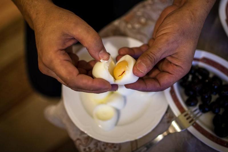 hardboiled egg A person pulls apart a hardboiled egg.
