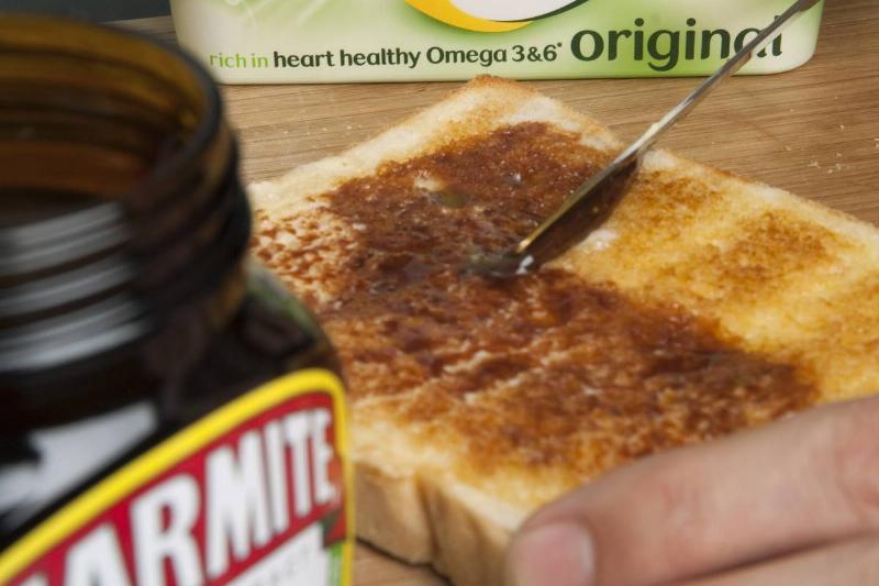 marmite toast A person spreads marmite on white toast.