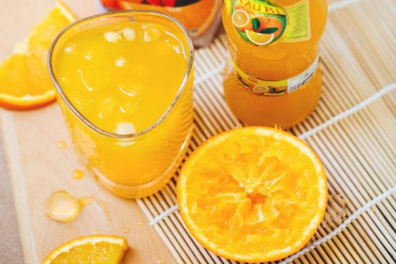 orange juice Orange juice is seen bottled and in a glass.
