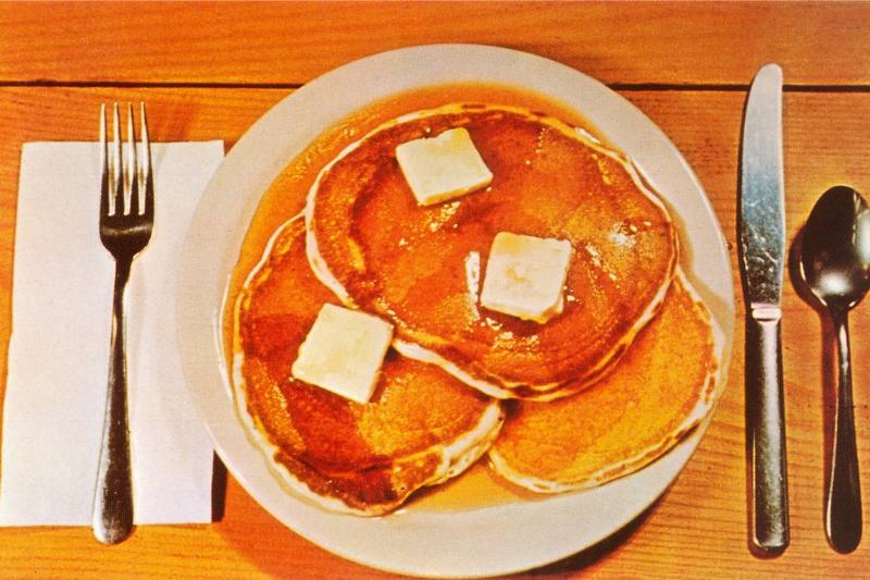 Pancakes A vintage color photograph shows pancakes on a place setting.