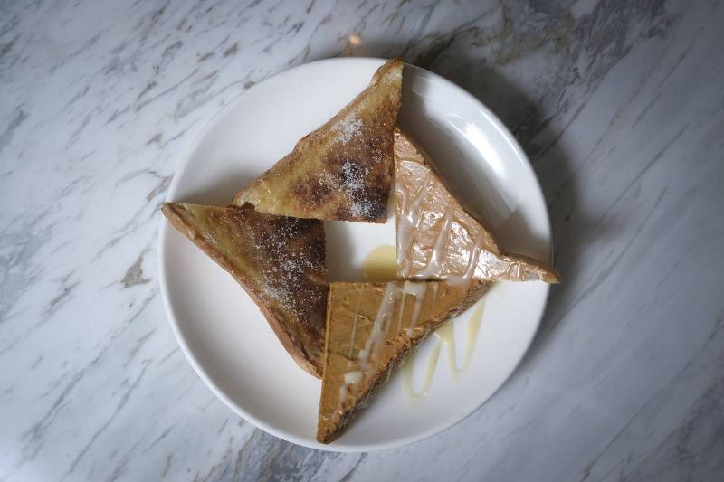 peanut butter toast Triangle-shaped pieces of toast have peanut butter and condensed milk.