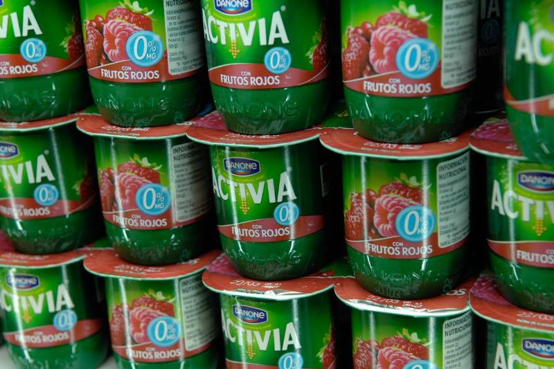 Activia yogurt containers are stacked in a grocery store.