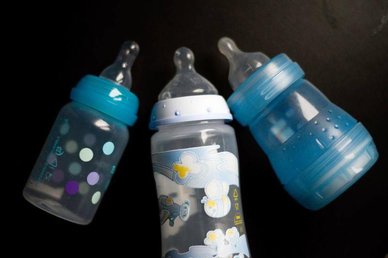 bottles Three baby bottles lie on a table.