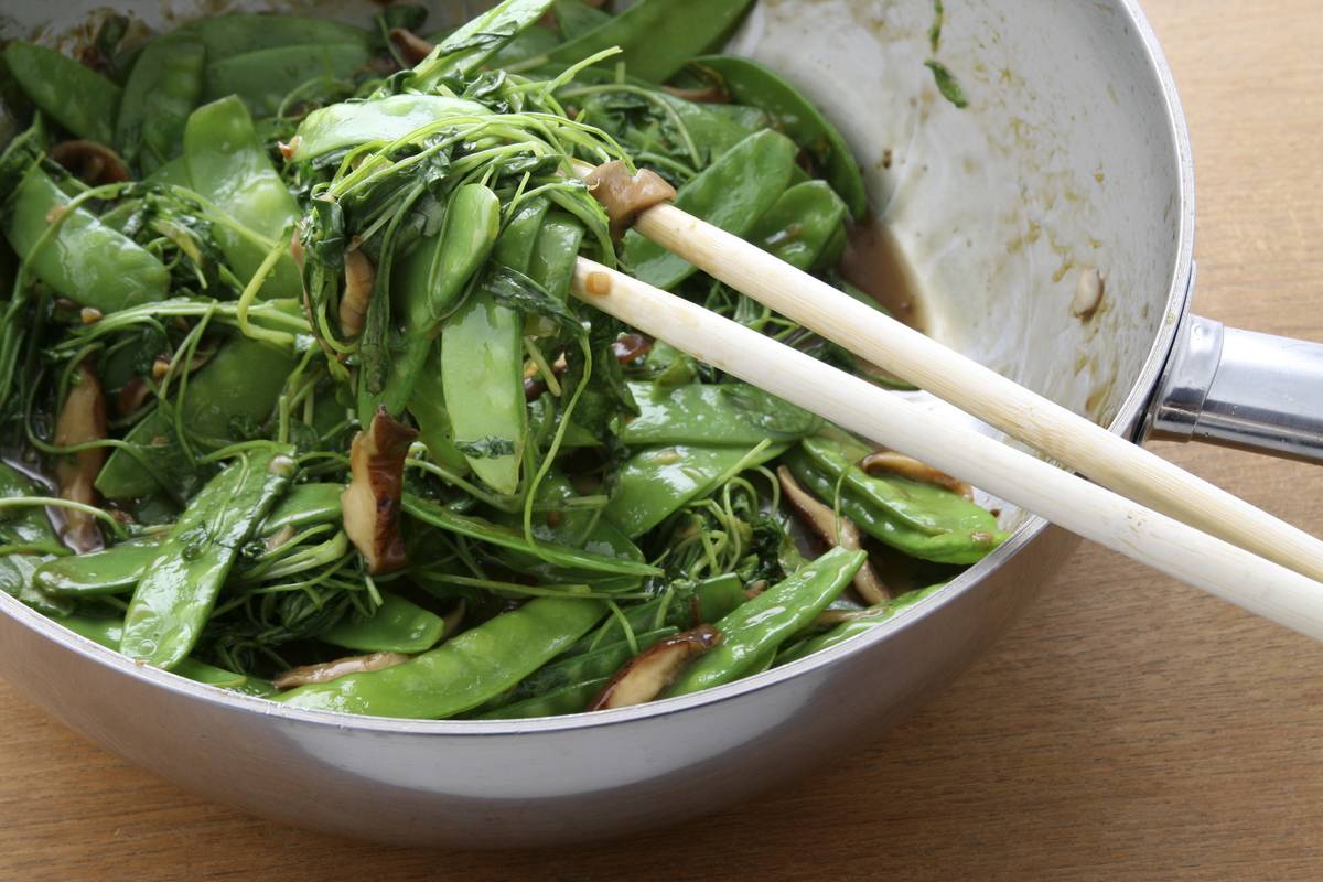 watercress Chopsticks pick up cooked watercross.