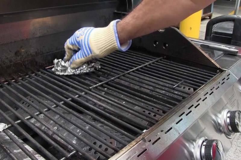 Picture of person cleaning the grill