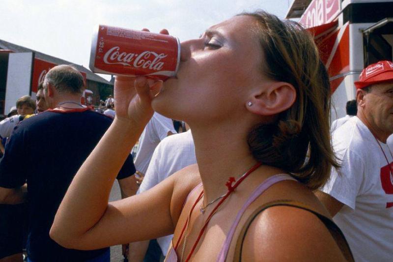 drinking Coke A woman drinks from a Coca-Cola can.