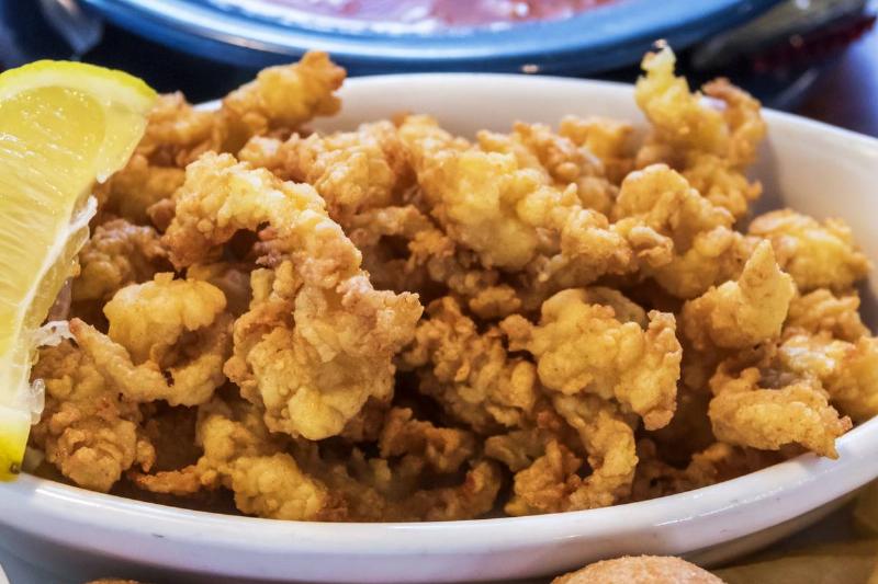 fried foods Fried clams and hush puppies are portrayed next to sauce in a North Carolina restaurant.