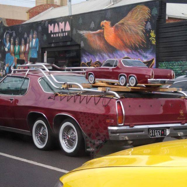 small red car on big red car