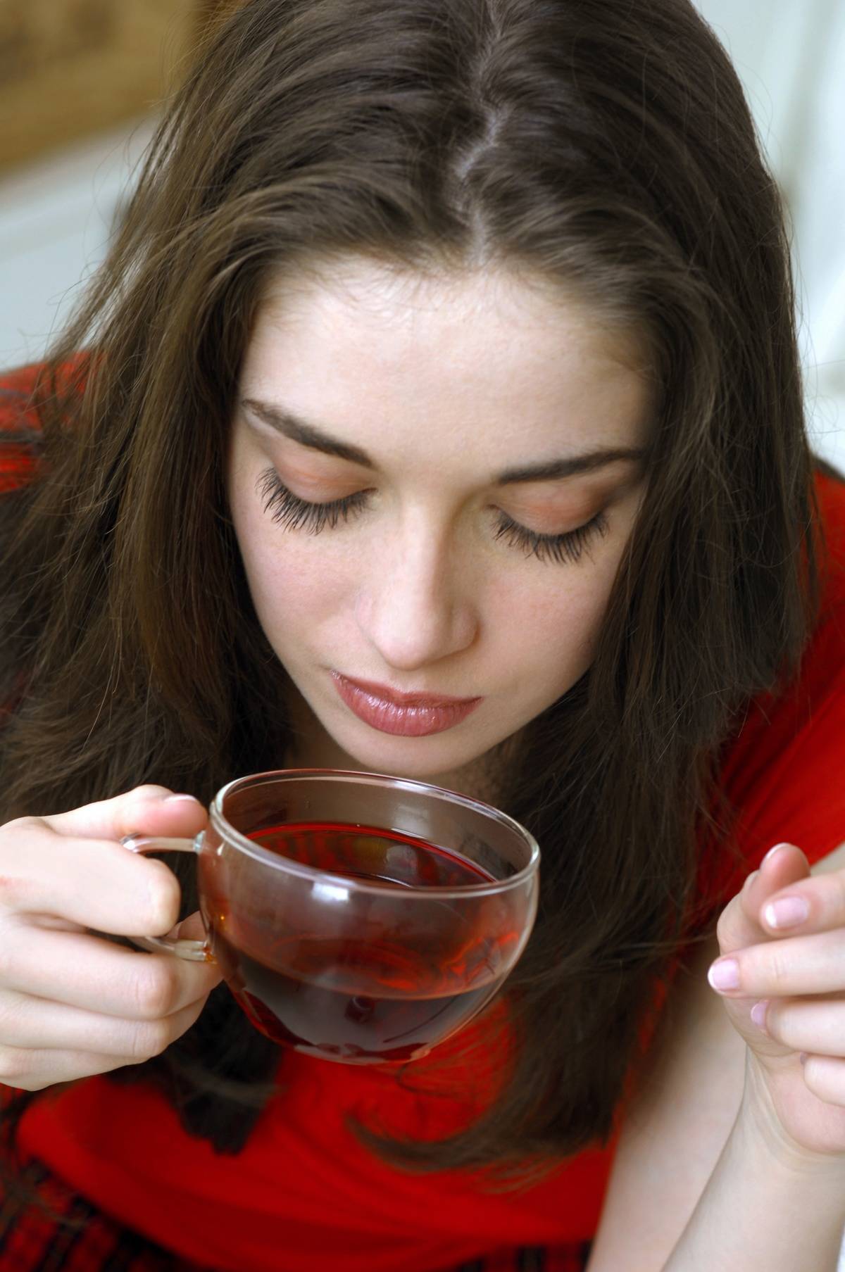 WOMAN DRINKING AN HERBAL TEA