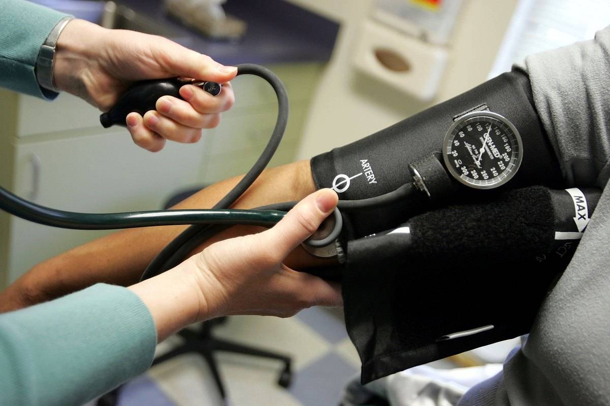 Dr. Elizabeth Maziarka reads a blood pressure gauge during an examination of patient June Mendez at the Codman Square Health Center April 11, 2006 in Dorchester, Massachusetts