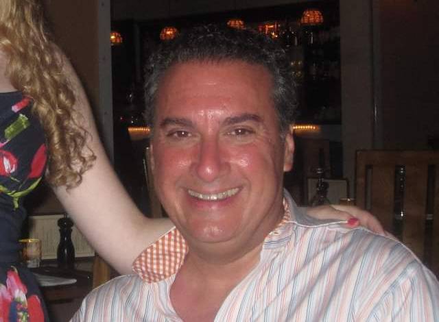 Joe Cartellone is pictured in a photo with Rebecca's arm on his shoulder.