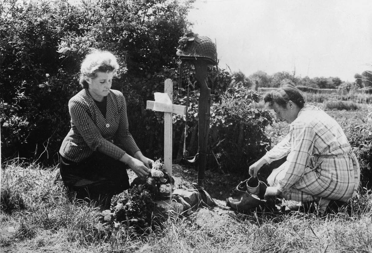 decorating grave During World War II, two women decorate a grave.