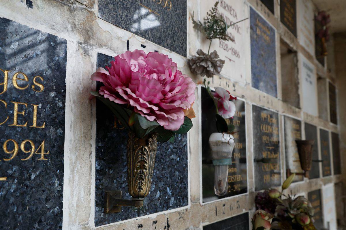 flowers hanging Flowers are laid on funeral urns in the Pere Lachaise cemetery.