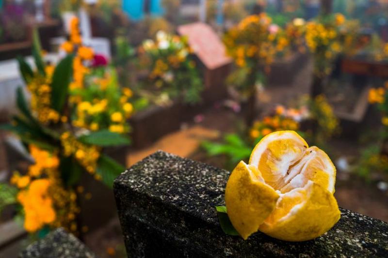 lemon grave A lemon was placed on top of a headstone in a cemetery during the Day of the Dead.