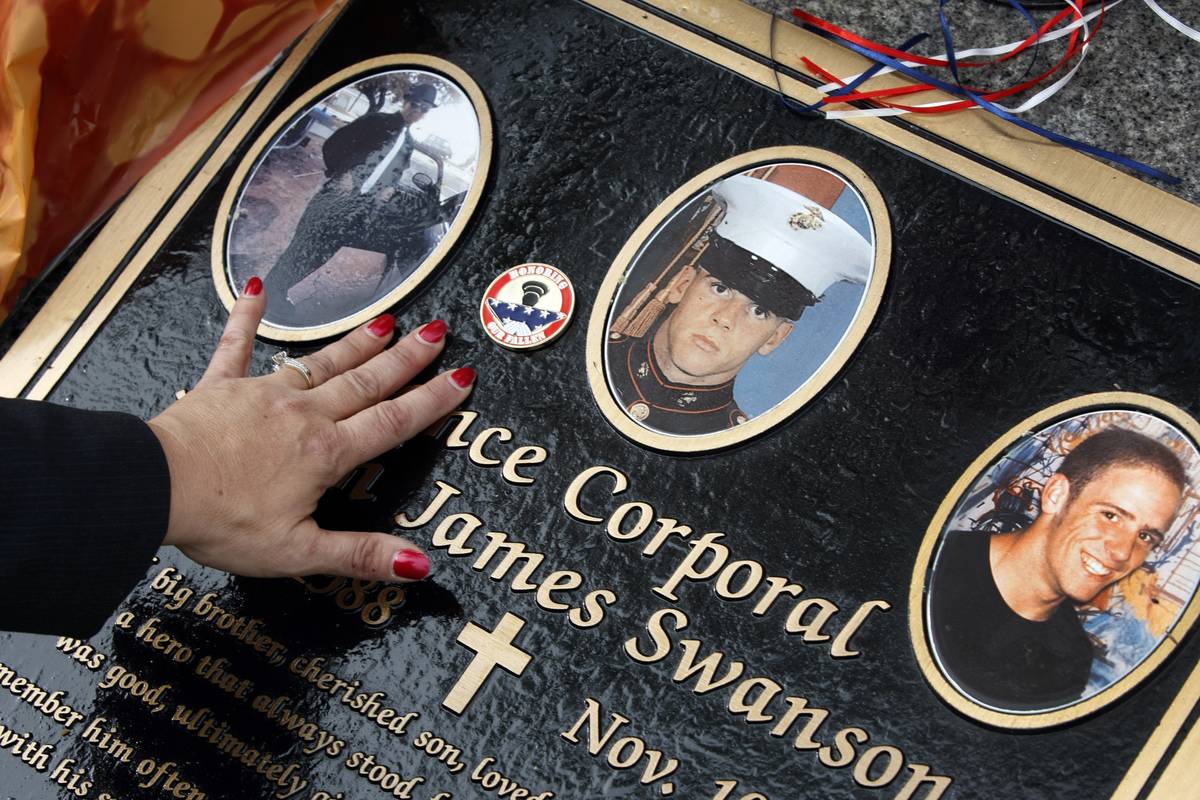 military grave A woman touches a corporal's grave.