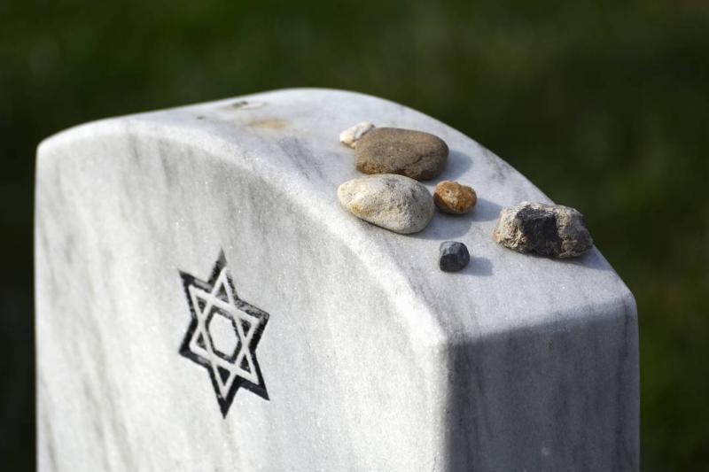 rocks on headstones Rockers have been placed on top of a Jewish headstone.