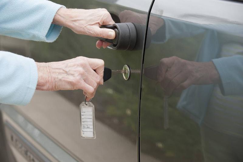 Using a key to unlock car door Using a key to unlock car door
