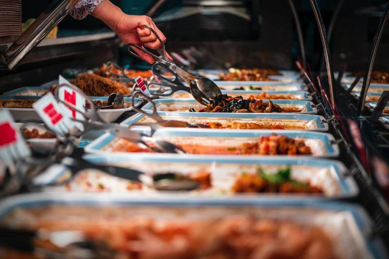 buffet person getting food at a buffet