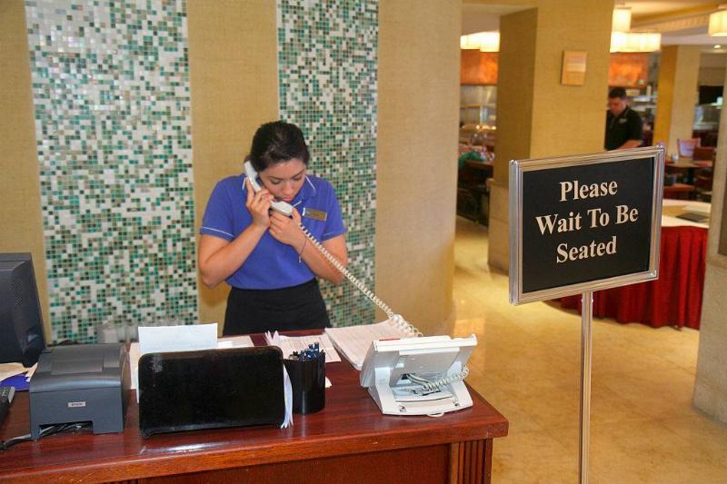 reservation 635713410 a hostess talking on the phone at a restaurant