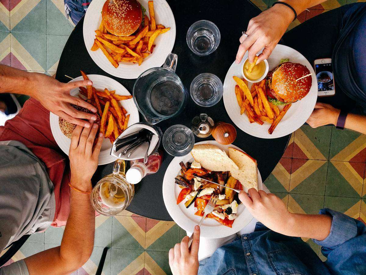high view of people eating with water glasses