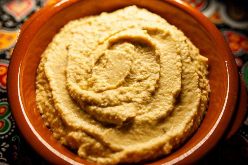 hummus dip in a red bowl