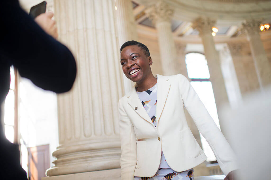 Danai Gurira wears all white and poses inside marble room