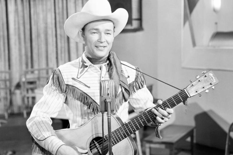 Roy Rogers holds acoustic guitar