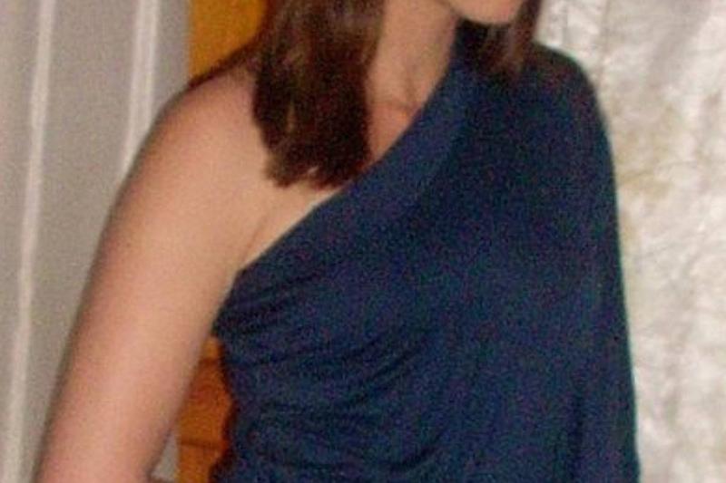 asymmetrical neckline woman in a blue shirt with an asymmetrical neckline