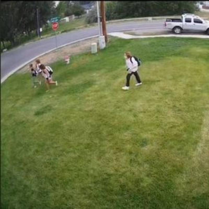 kids backpacks walking kids cutting across lawn