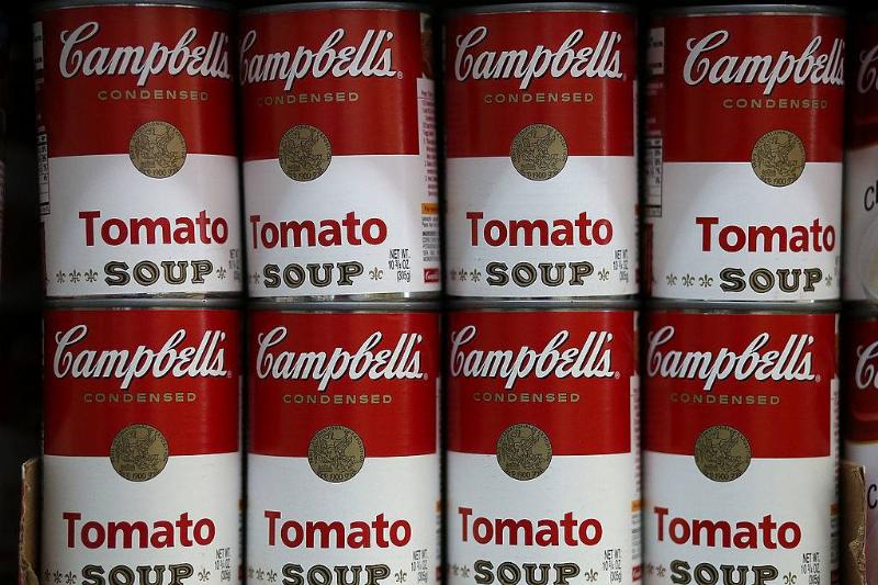 soup 169124935 Cans of Campbell's tomato soup are displayed on a shelf