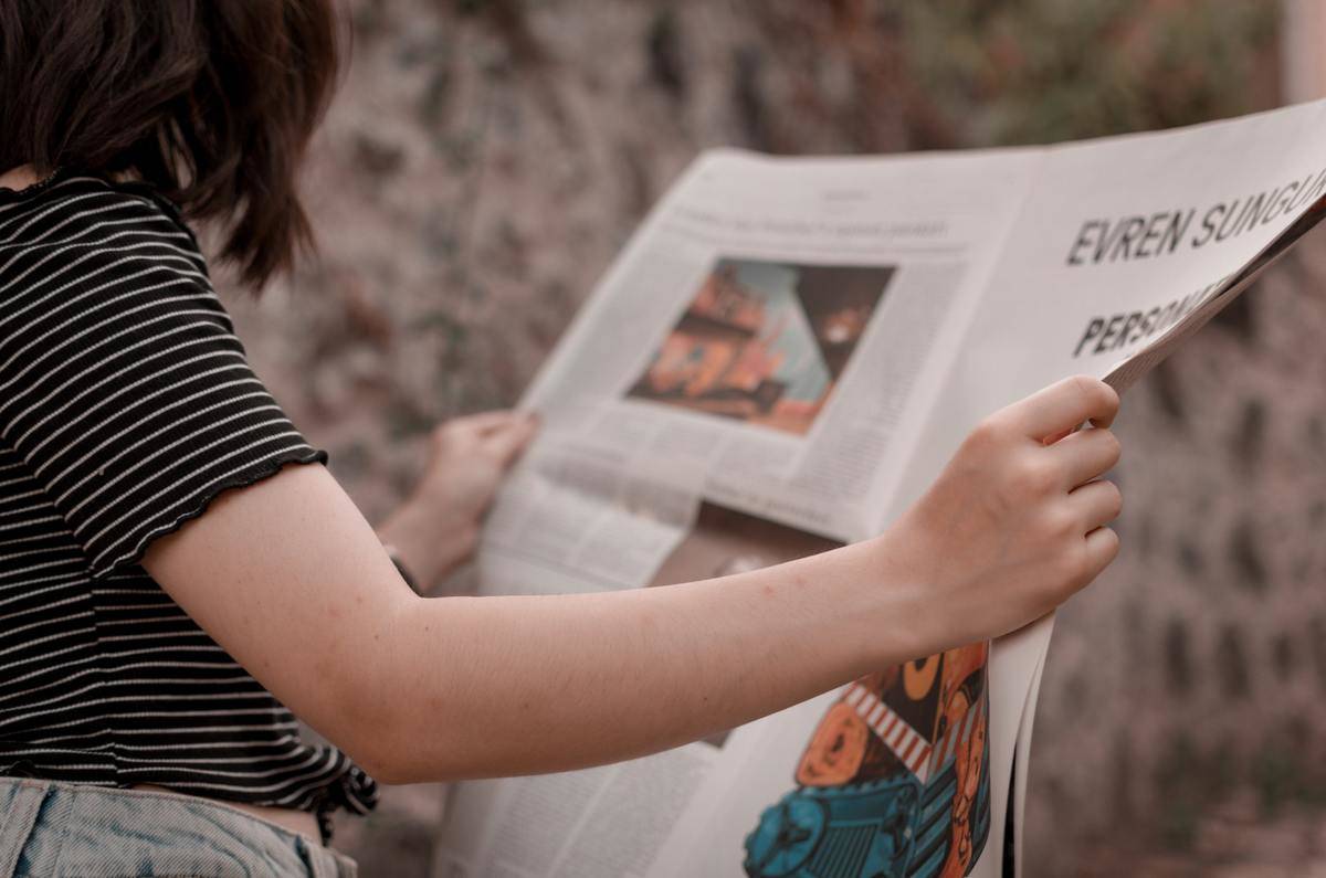 News Paper Young woman looking in news paper
