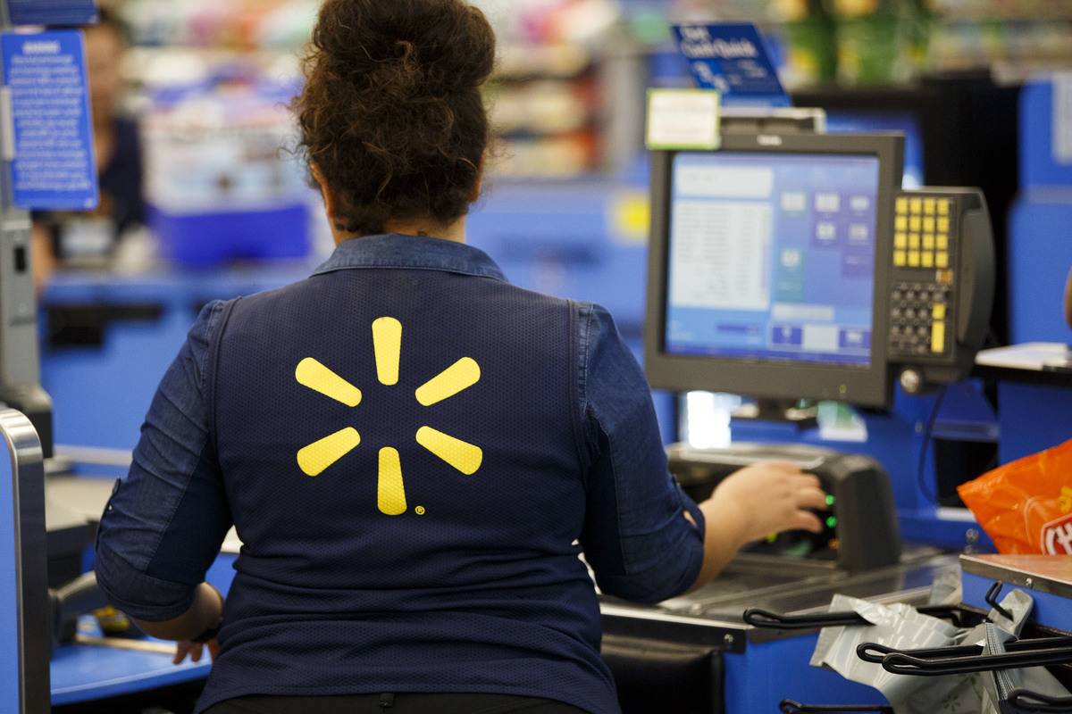 Wal-Mart Store An employee scans items at a cash register at a Wal-Mart Stores Inc. location in Burbank, California, U.S., on Tuesday, Aug. 8, 2017. Wal-Mart Stores is scheduled to release earnings figures on August 17.