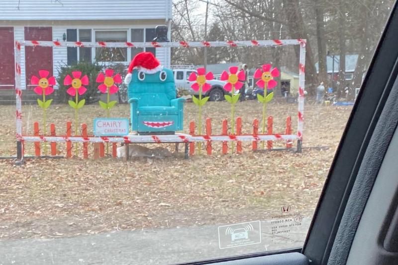 Christmas lawn display with happy flowers and Chairy from Pee Wee's Playhouse in Santa hat