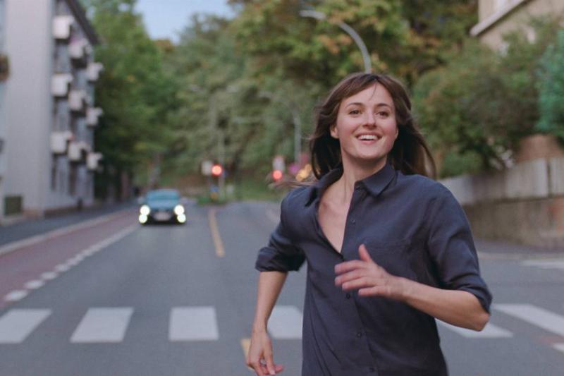 woman running down the street smiling