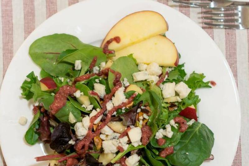 Greek salad with feta, apples slices, and pistachios Greek salad with feta, apples slices, and pistachios