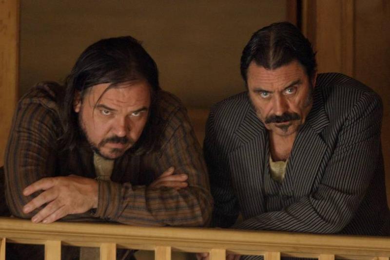 Ian McShane and W. Earl Brown scowling from stair railing in Deadwood Ian McShane and W. Earl Brown scowling from stair railing in Deadwood
