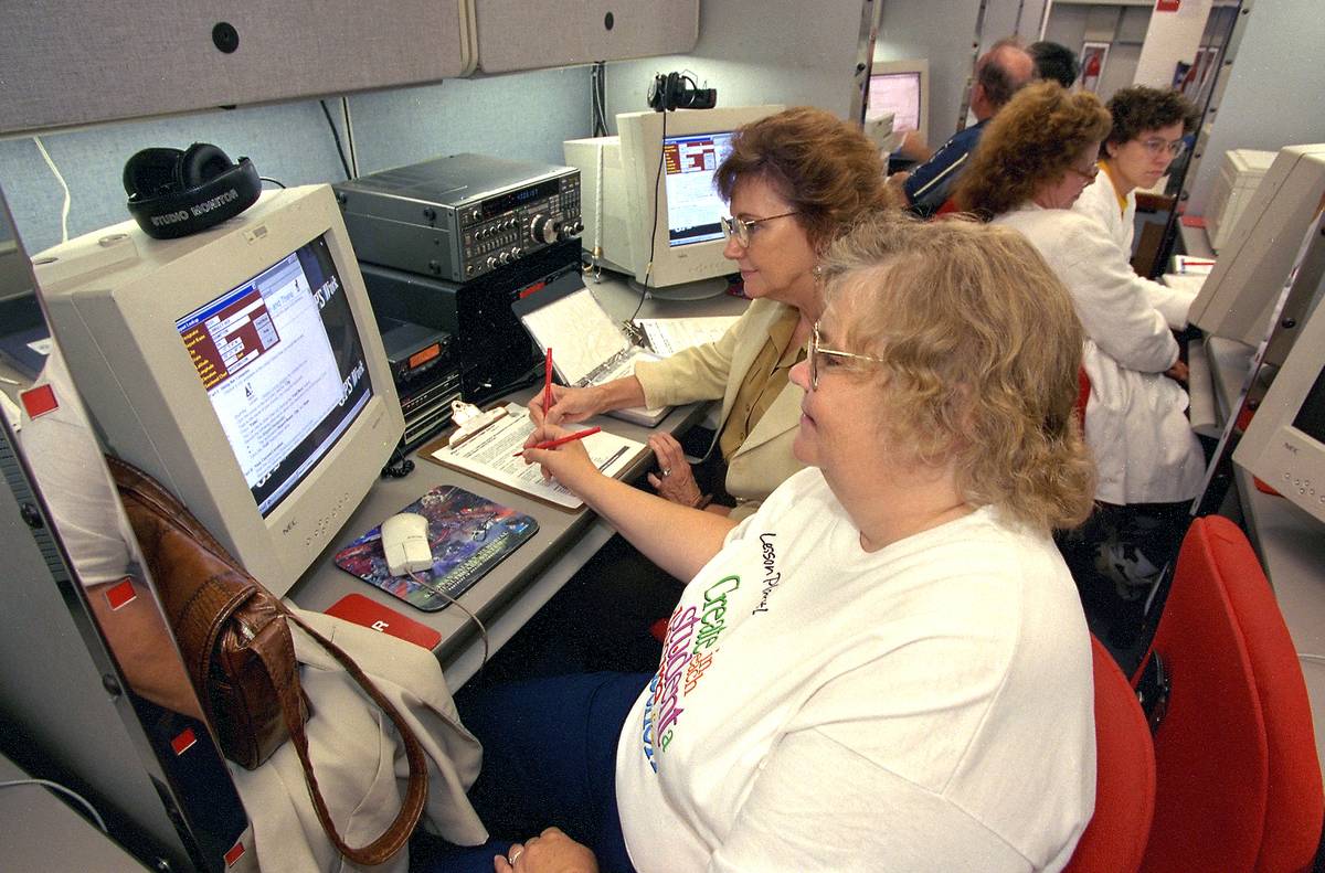 Teacher workshop in late 1990s with teachers working on 20th century computers Teacher workshop in late 1990s with teachers working on 20th century computers