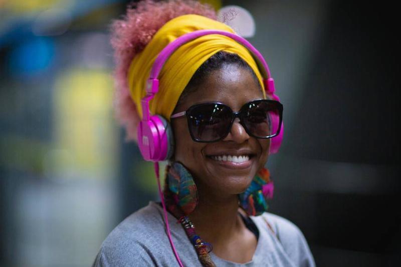 Woman smiling in sunglasses and headphones Woman smiling in sunglasses and headphones