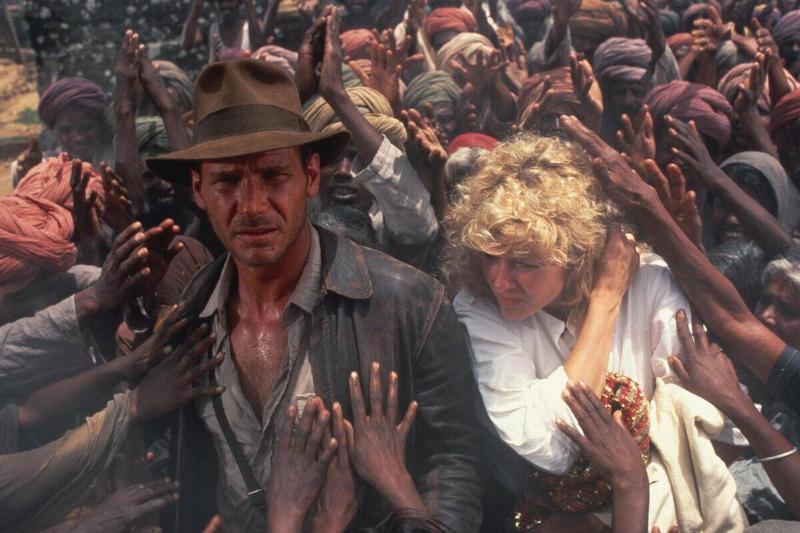 Harrison Ford and Kate Capshaw walking through crowd of beggars as Indiana Jones and Willie Scott Harrison Ford and Kate Capshaw walking through crowd of beggars as Indiana Jones and Willie Scott