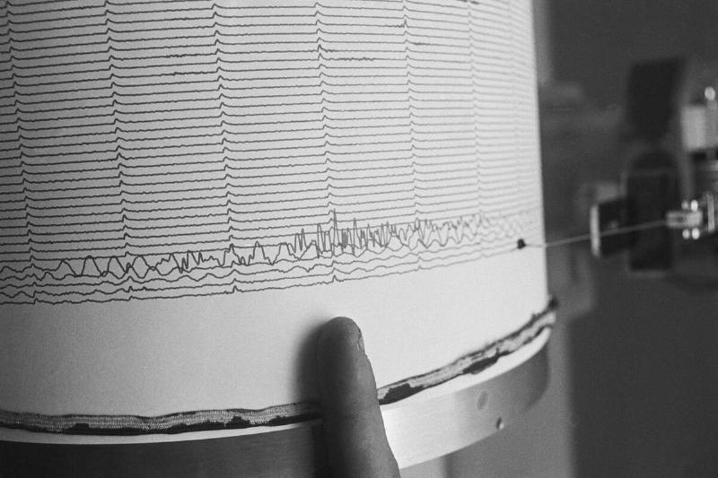 Finger Pointing to Earthquake Reading on Seismograph Finger Pointing to Earthquake Reading on Seismograph