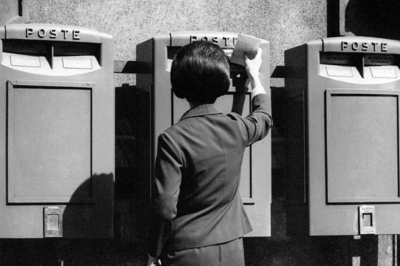 A woman mailing a letter A woman mailing a letter