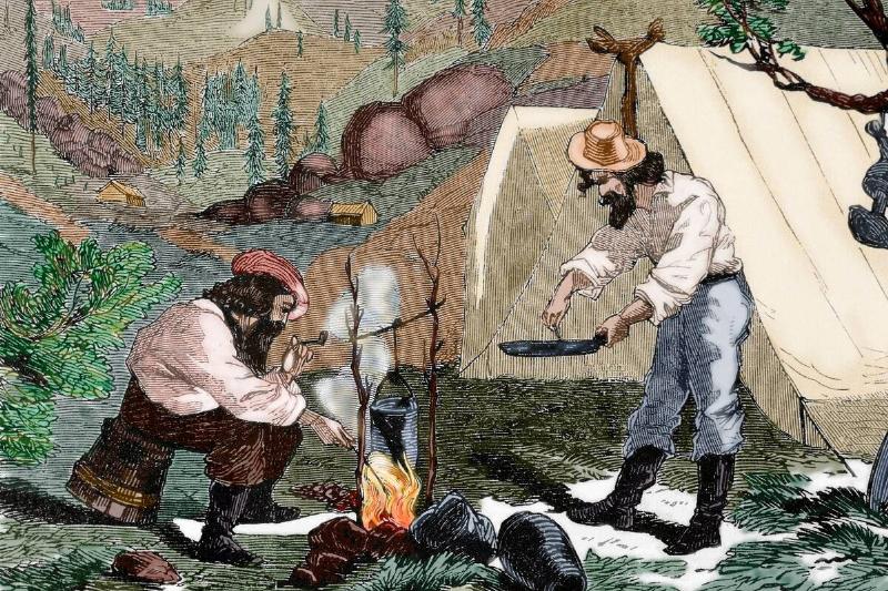 USA. Gold Rush. 19th century. Gold prospectors cooking. Engraving. Colored. USA. Gold Rush. 19th century. Gold prospectors cooking. Engraving. Colored.
